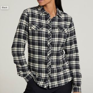 close up of a model wearing a black and white checked shirt