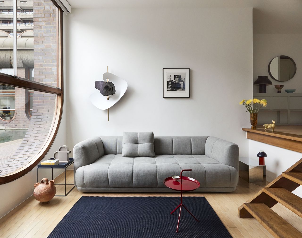 A small living room with grey sofa