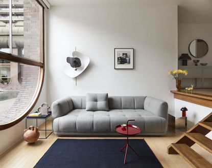 A small living room with grey sofa