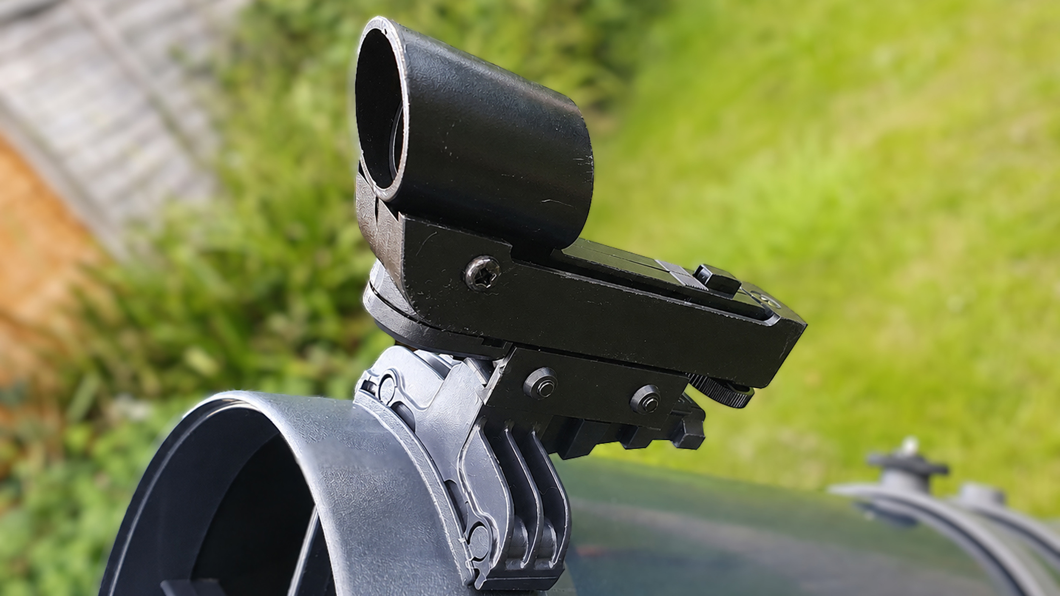 A close up of a telescope, showing the tube-mounted finderscope.