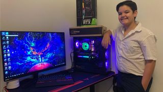 Ricardo Santana jr standing next to his gaming PC smiling