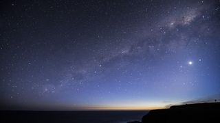 a photo of the night sky with the Milky Way and Venus visible