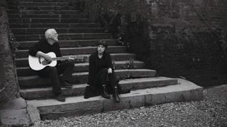 David Gilmour sitting on steps with daughter Romany