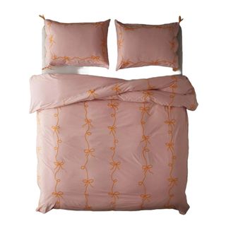 A pink duvet cover with lacy bows