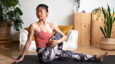 A woman performing the static stretch 'spinal twist'