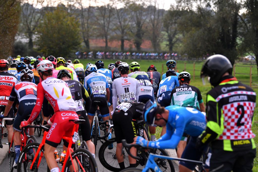 OUDENAARDE BELGIUM OCTOBER 18 Travis Mccabe of The United States and Team Israel StartUp Nation Alberto Dainese of Italy and Team Sunweb Eduard Prades Reverte of Spain and Movistar Team Crash Peloton during the 104th Tour of Flanders 2020 Ronde van Vlaanderen Men Elite a 2433km race from Antwerpen to Oudenaarde RVV20 FlandersClassic on October 18 2020 in Oudenaarde Belgium Photo by Luc ClaessenGetty Images
