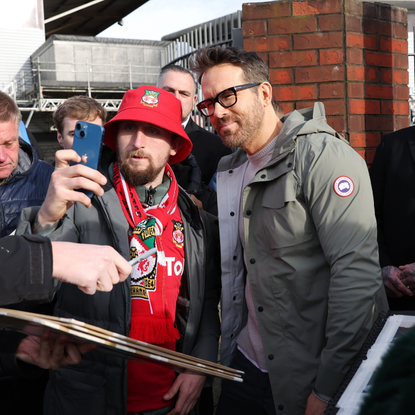 Ryan Reynolds the owner of Wrexham signs autographs for supporters prior to the Emirates FA Cup Fourth Round match between Wrexham and Sheffield United at Racecourse Ground on January 29, 2023 in Wrexham, Wales.