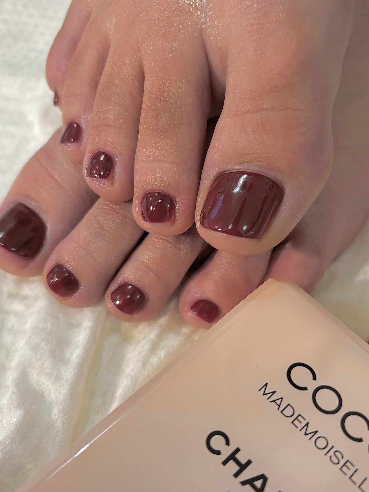 A brick red pedicure colour painted on toes