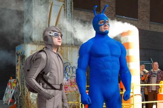 two men dressed up like super hero bugs at a construction site in the show the tick