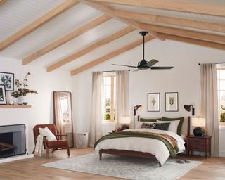 neutral bedroom with white walls and wood beamed ceiling