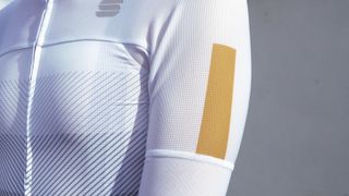 A closeup of a gold detail on one of the best cycling jerseys from Sportful