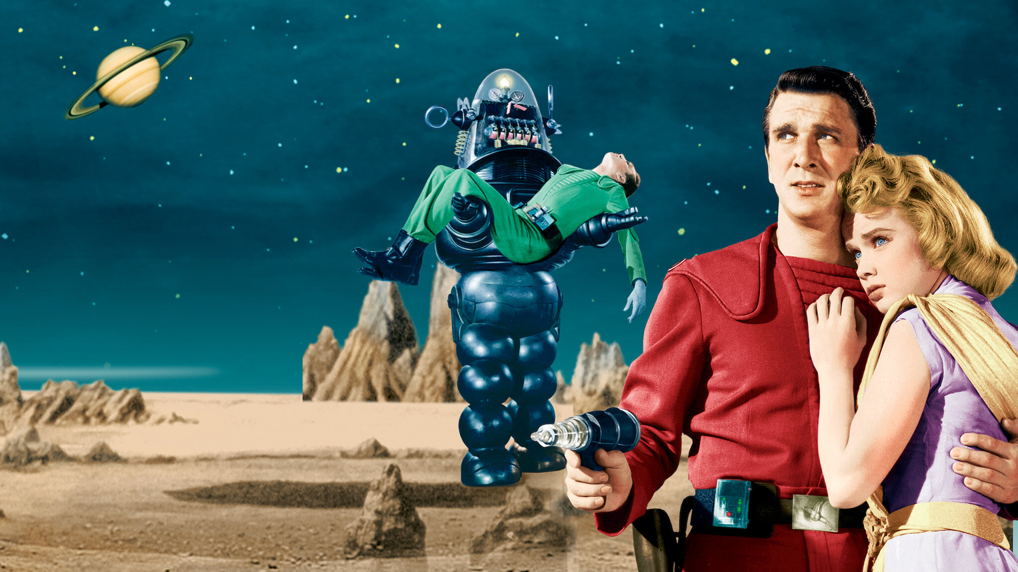 Promotional art for the 1956 sci-fi movie "Forbidden Planet", used as the cover art on Netflix. It shows a man in a red jumpsuit holding a ray gun, with a blonde woman holding him. We can also see a robot carrying an unconscious man in a green jumpsuit across a desert scene at night.
