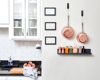 kitchen with Command hooks on the wall for copper pans
