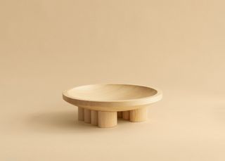 Vaarnii wooden bowl by Mac Collins on pale background