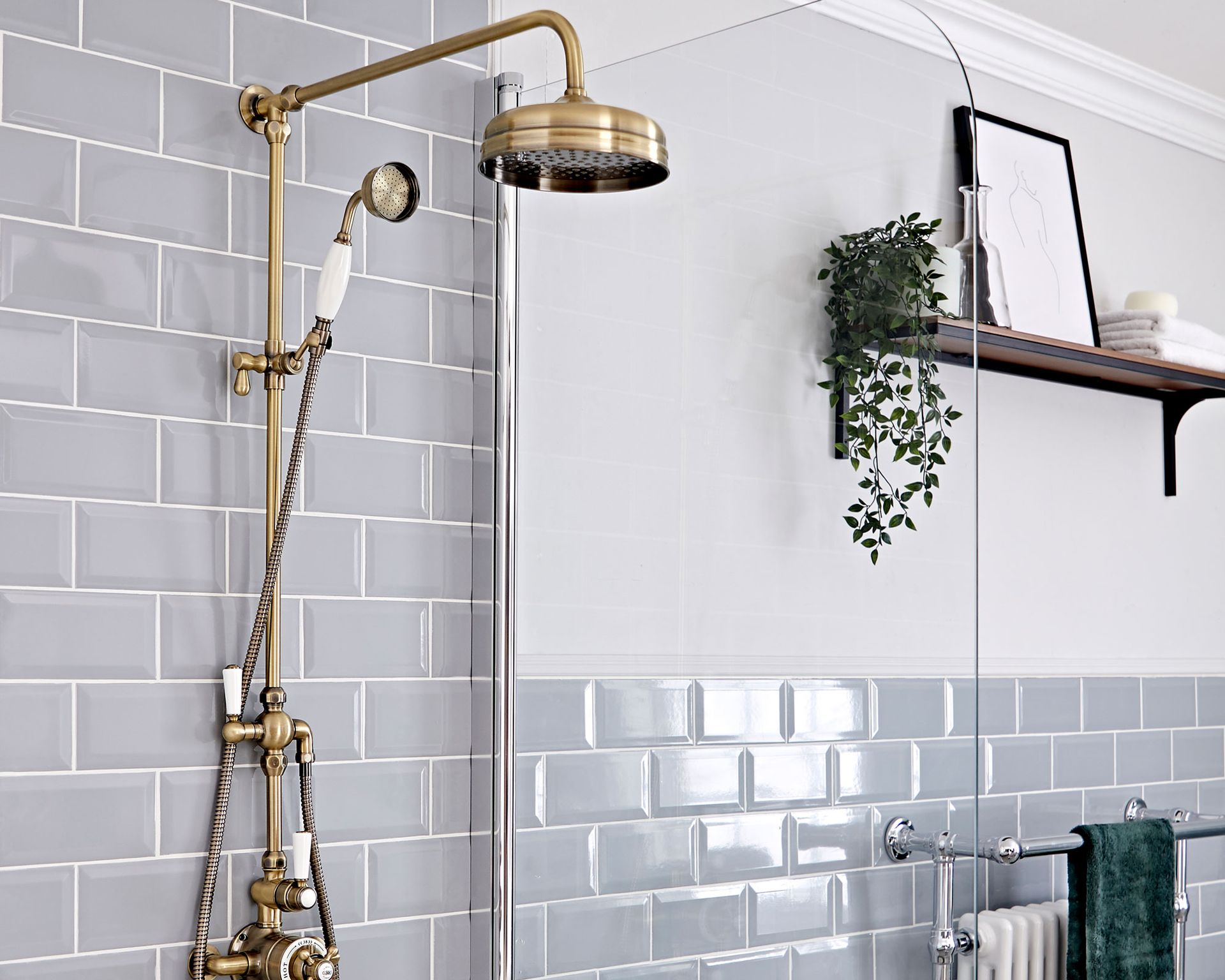gold shower head in blue bathroom
