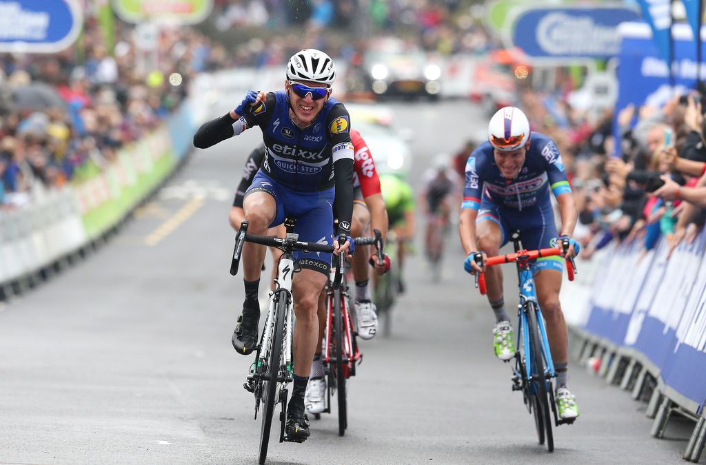 Dan Martin punches the air in celebration of teammate Julien Vermote (Etixx-QuickStep) winning the stage