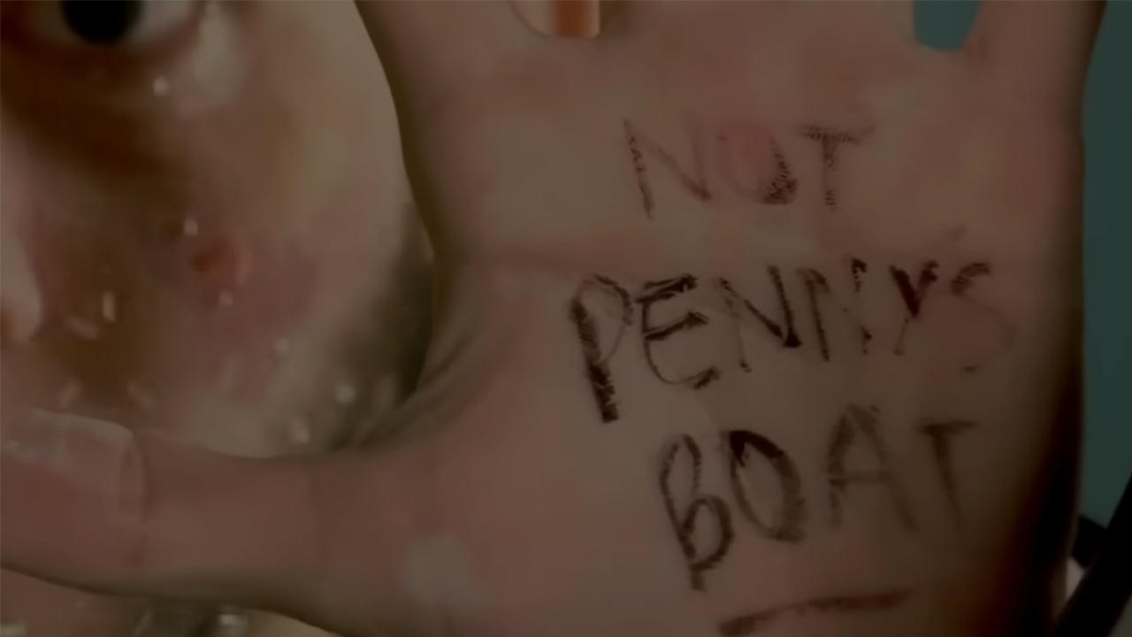 Charlie holding his hand up with &amp;quot;not Penny's boat&amp;quot; written on it in Lost