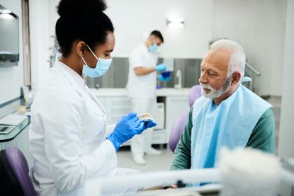 A dentist speaks with a patient. 