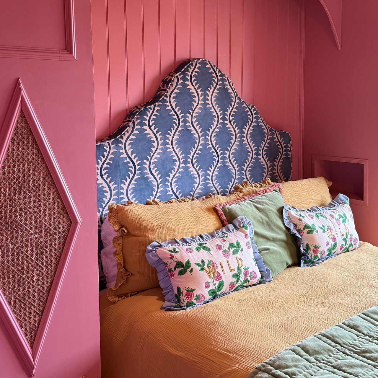 Roisin Quinn's dark pink bedroom has alcoves built into the side of the wardrobes either side of her Button &amp; Sprung bed