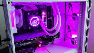 AMD Radeon RX 6600 in a computer, powered on with lots of pink lighting