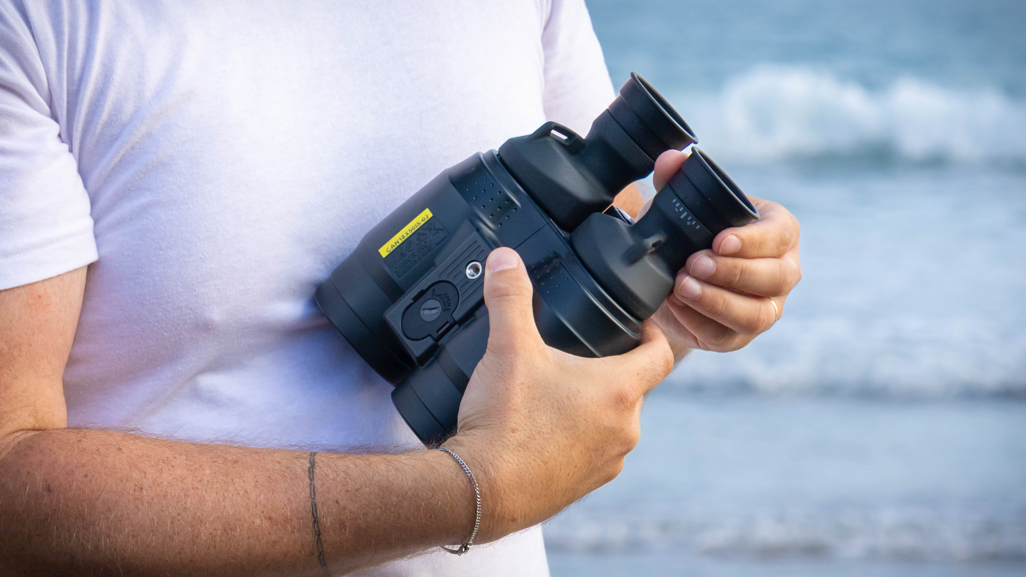 A close up of the back of the Canon 18x50 IS binoculars, showing the strap holders.