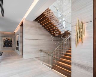 A staircase lighting idea by John Cullen Lighting with warm white contour LED strip under stead treads