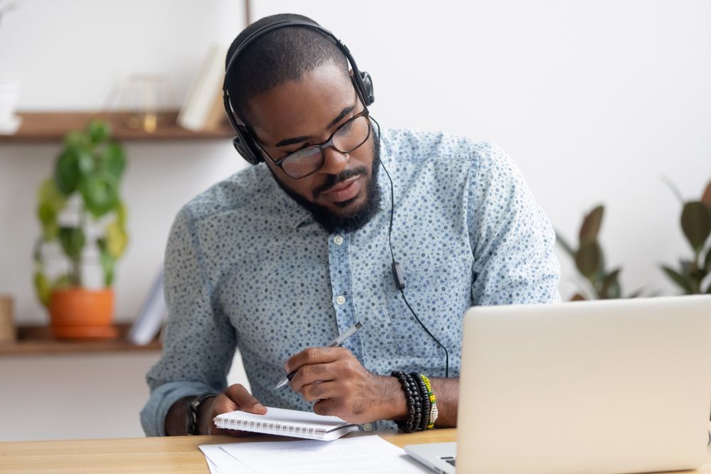 A man learning at home via a laptop