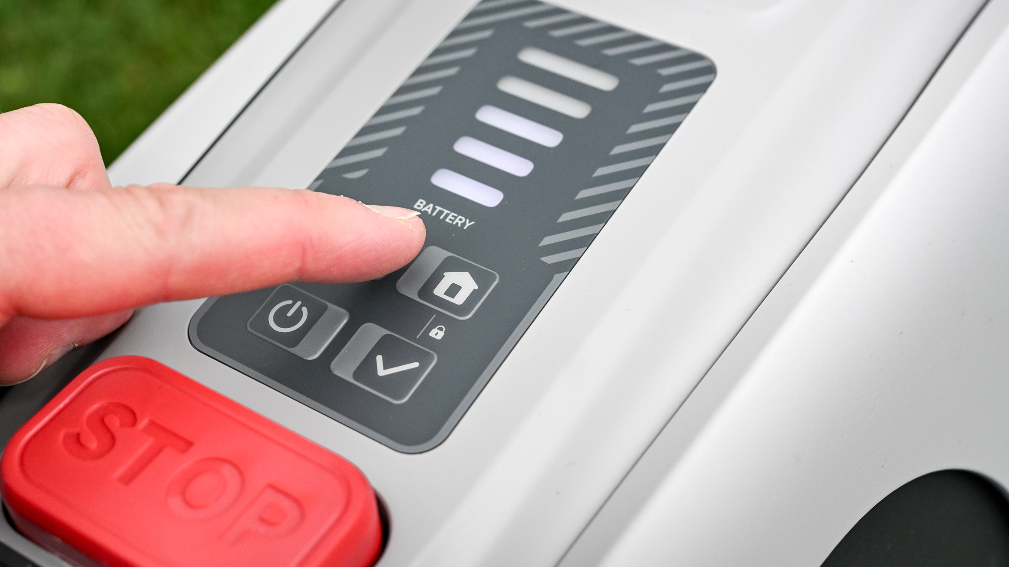 The Eufy E15 robot lawnmower controls being pressed