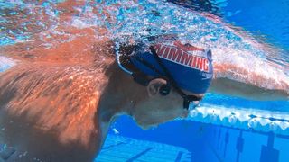 H2O Tri headphones, worn by a swimmer, underwater