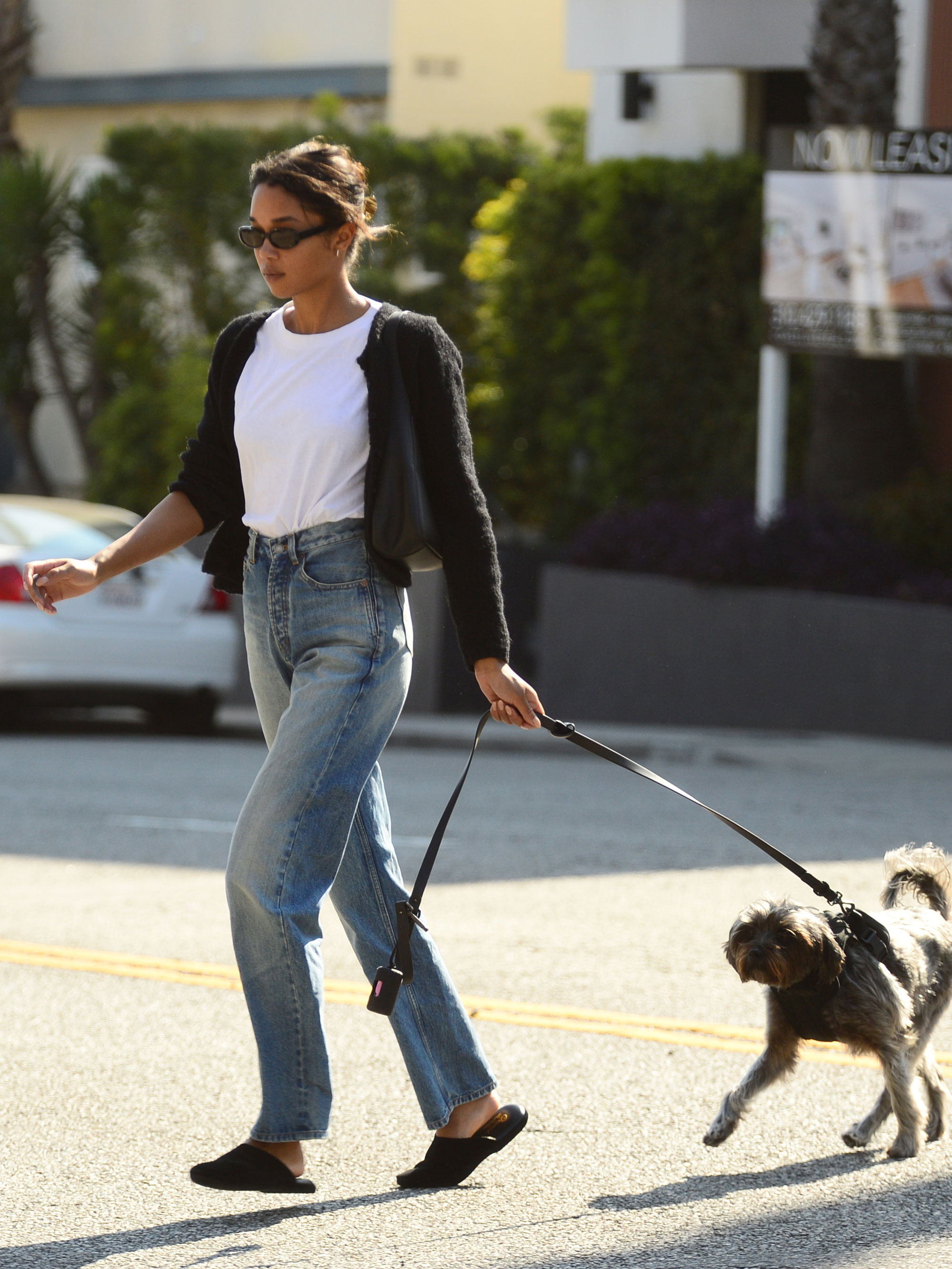 Laura Harrier wears straight-leg jeans and mules