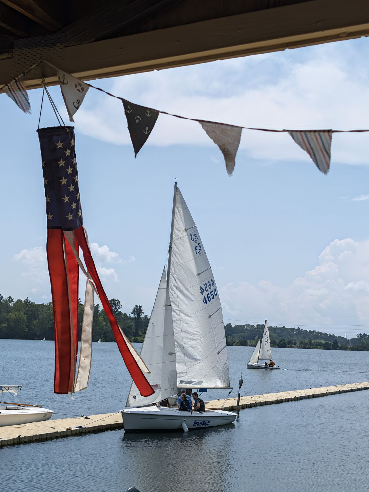 A 2x zoom photo sample of sailboats and an American flag, taken with a Google Pixel 11 Pro
