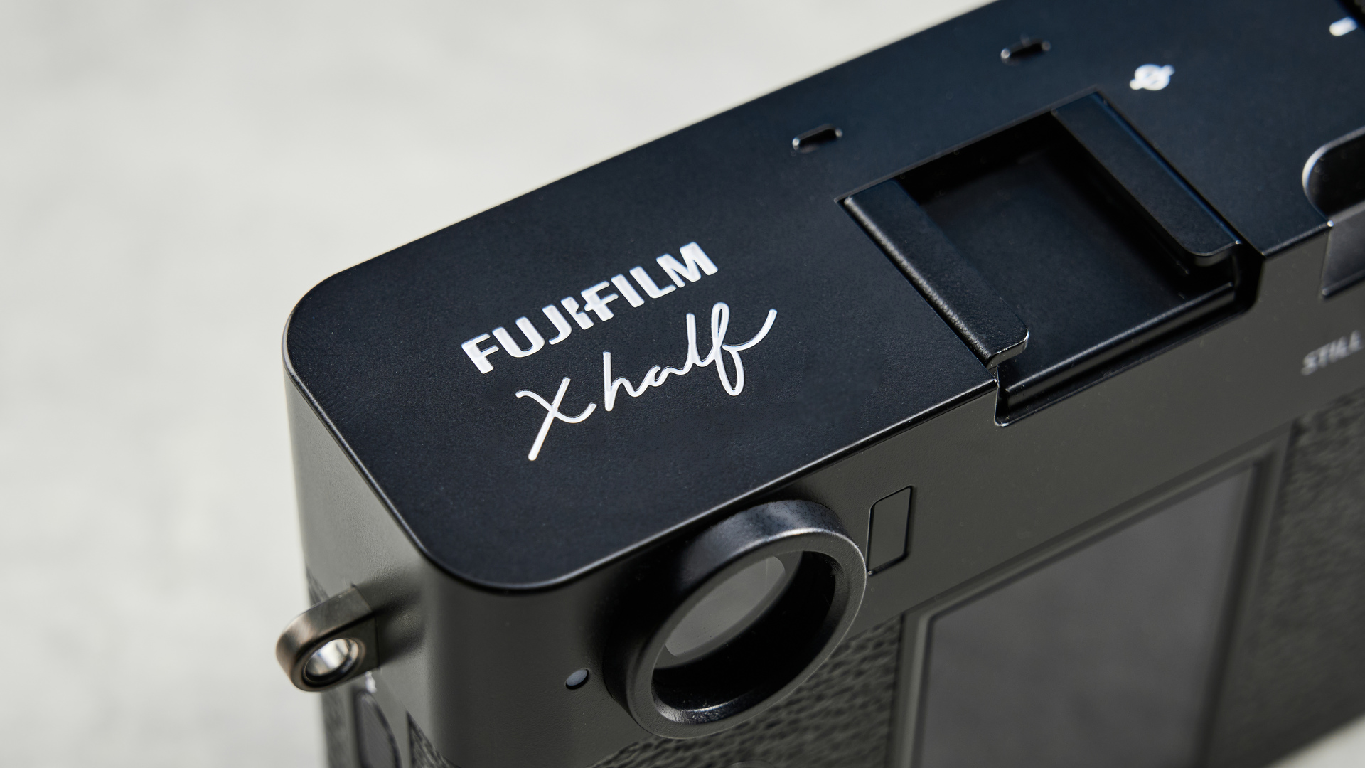 A black Fujifilm X half camera