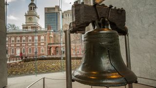 The Liberty Bell and Independence Hall in the back ground at at Philadelphia's Independence National Historic Site.