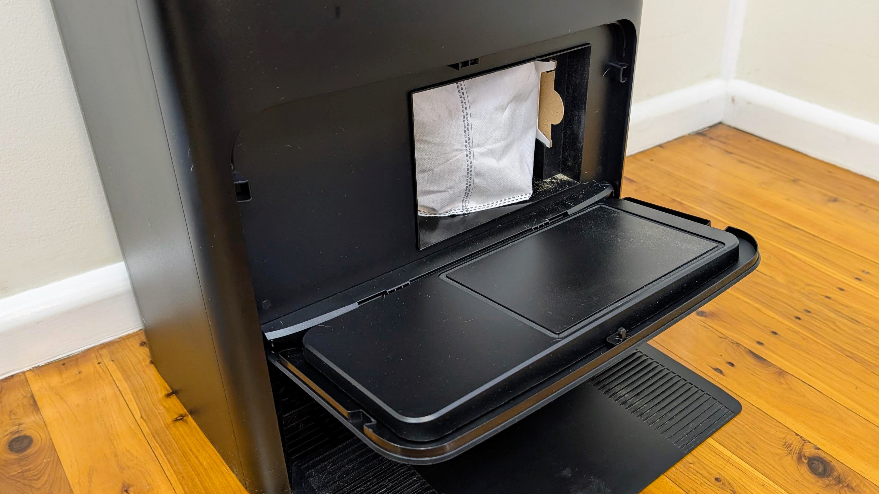 Ecovacs X5 Pro Omni base station showing front cover open and dust bag visible