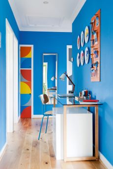 Bright blue hallway with desk space