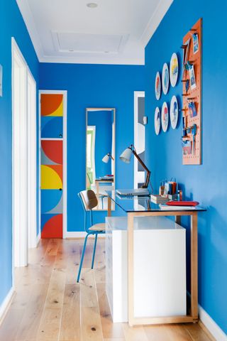 Bright blue hallway with desk space