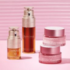 Beauty products sold at Clarins on pink background