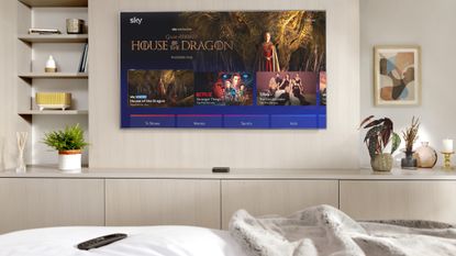 Sky Stream review: puck by bedroom TV with remote on the bed