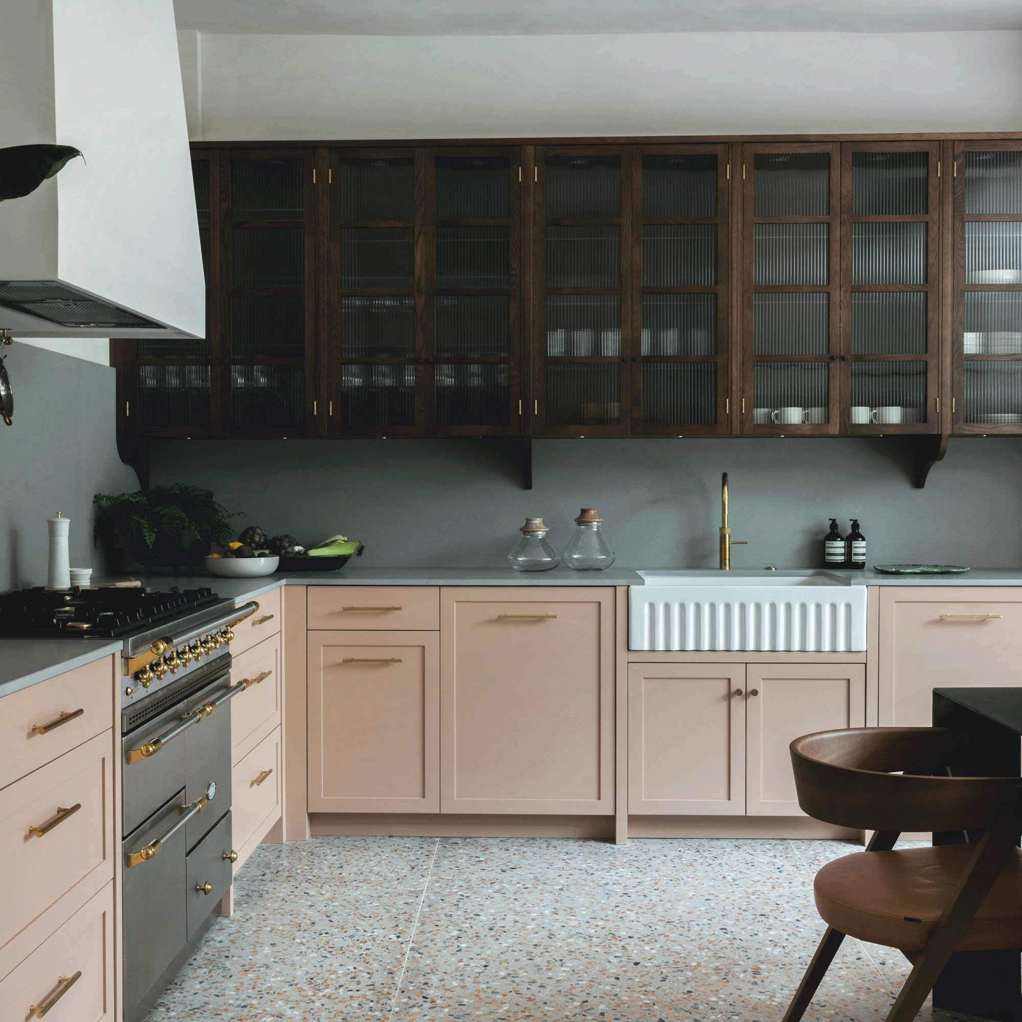 Two tone kitchen with pink and wood with terrazzo flooring