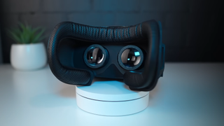 YouTube creator CNCDan showcasing his homemade VR headset while playing a racing sim.