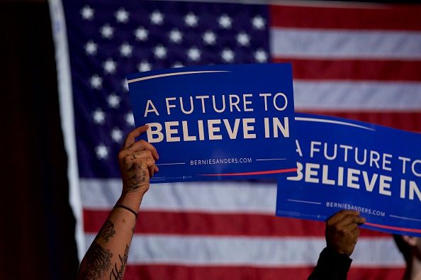 Bernie Sanders supporters hold signs.