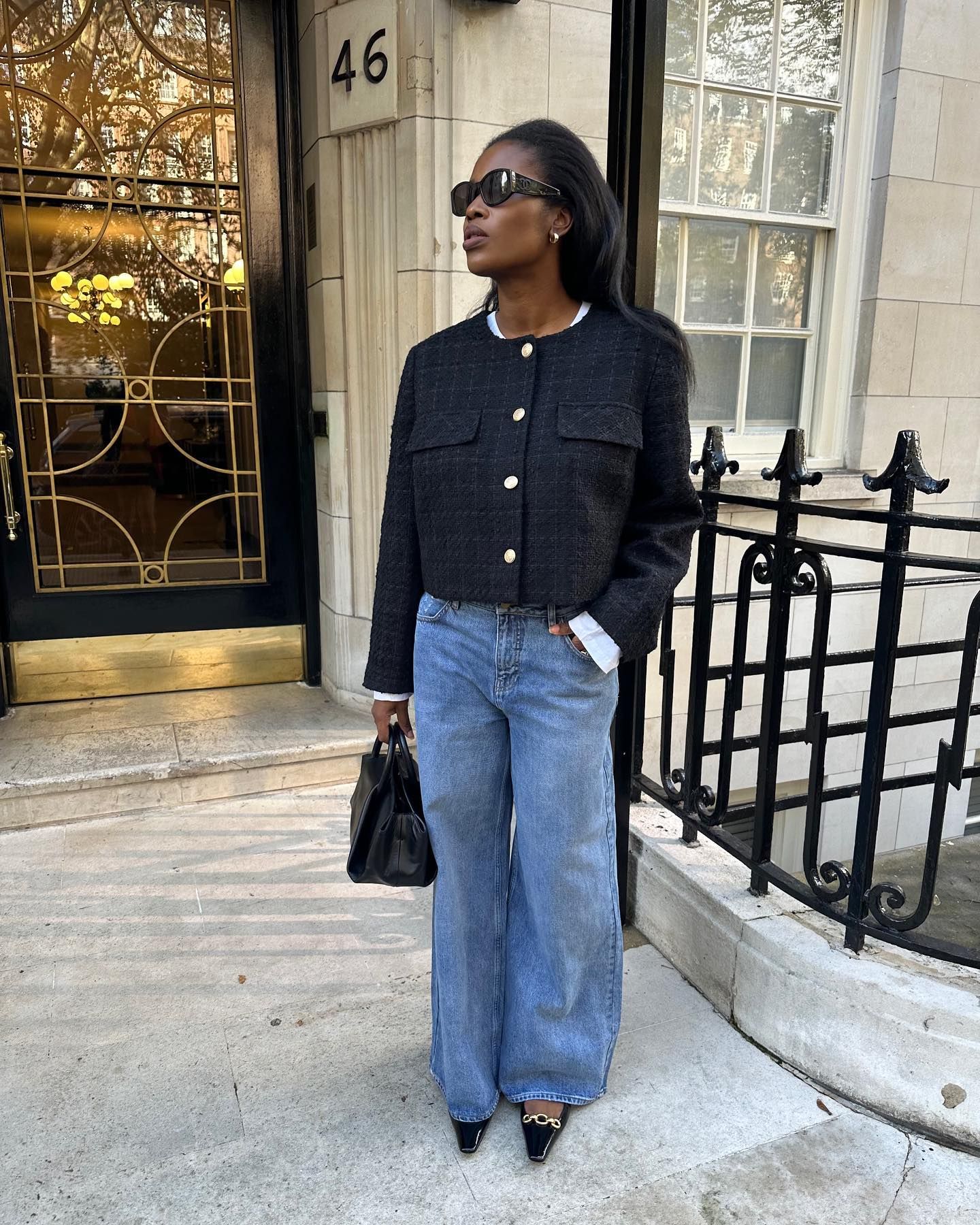 Girl wearing black jacket and low-rise jeans