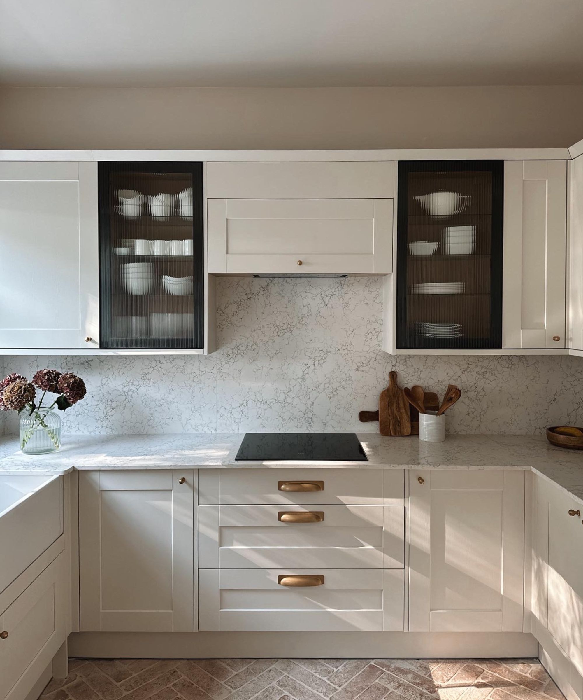 A neutral kitchen with white quartz countertops