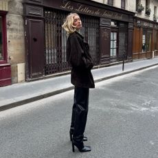 Elsa Hosk wearing leather trousers, boots and oversized coat with draped bob