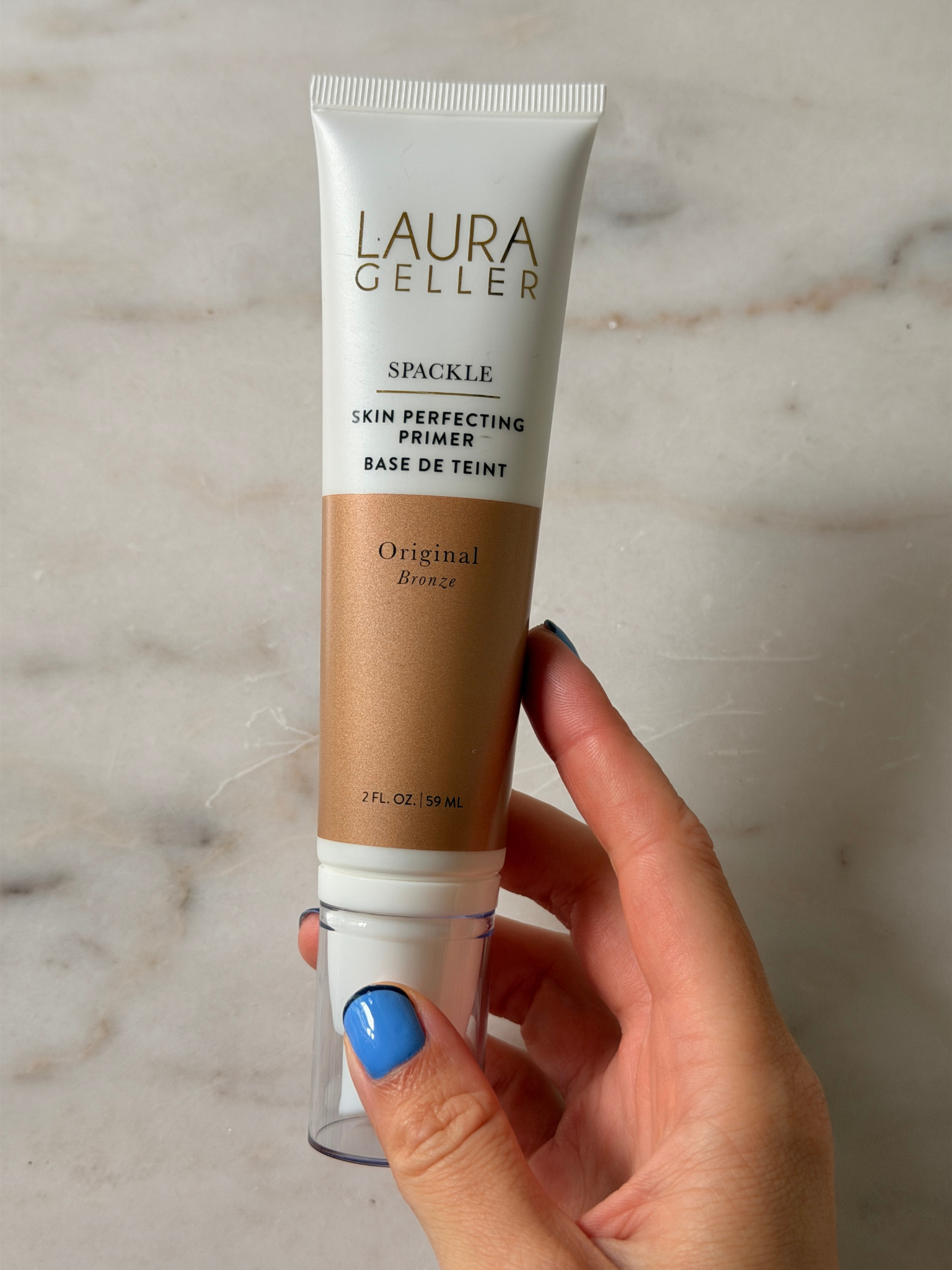 Grace holding the Laura Geller primer