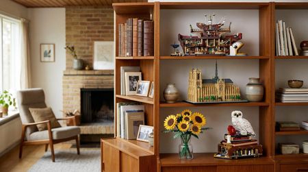 Different Lego sets arranged on a bookshelf