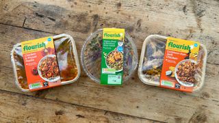 Three ready meal packets from the Sainsbury’s Flourish range in a line on a table