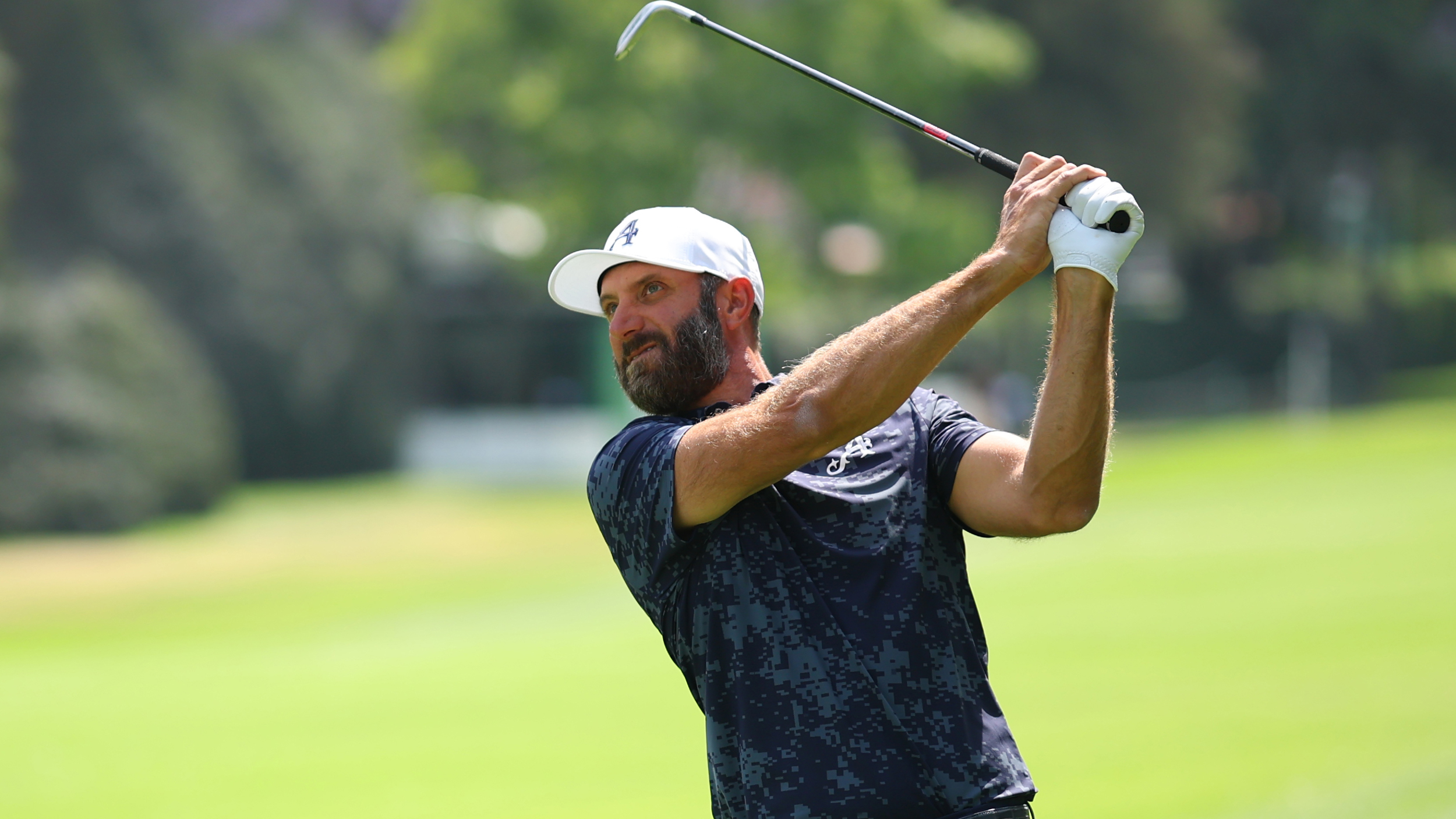 Dustin Johnson holds his finish on an iron shot