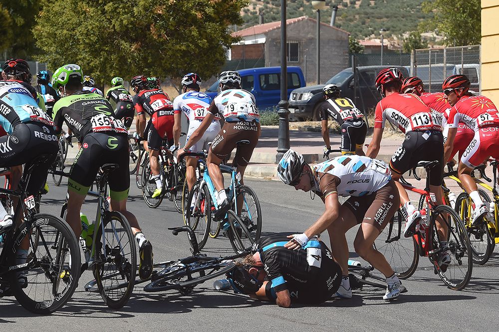 Gediminas Bagdonas checks on Vasil Kiryienka after the two crash