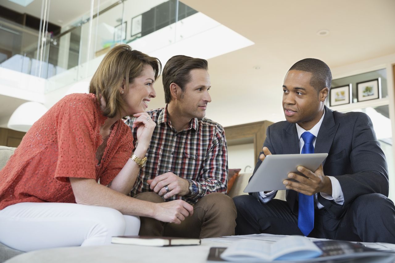 Couple talking to financial advisor in living room